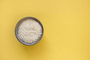 grey bowl with rice on background with copy space for your text, top view. Natural food high in protein photo