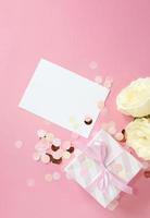 gift boxes and rose flowers on pink background. Happy Valentines day, Mothers day, birthday concept. Romantic flat lay composition. photo