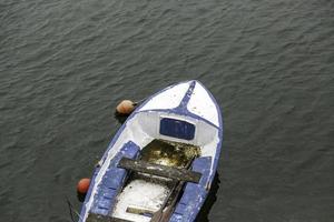 Old wooden boat in the sea photo