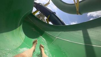 A man riding water slide and diving into the pool. Slow motion. video