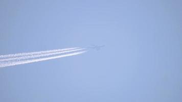 Contrails in the blue august sky. Airplane flying high. video