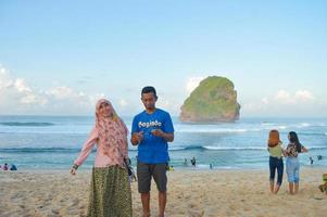 Gresik, East Java, Indonesia, 2022 - beach atmosphere with people meeting photos during the Eid al-Fitr holiday after the 2022 pandemic on the coast of Goa China, Malang