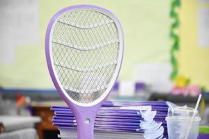 Electronic mosquito swatter in the office room for killing mosquitoes and insects inside the office, soft and selective focus. photo