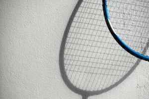 The shadow of badminton rackets on white wall, soft and selective focus, concept for badminton sport lover around the world. photo