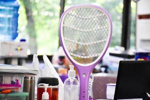 Electronic mosquito swatter in the office room for killing mosquitoes and insects inside the office, soft and selective focus. photo