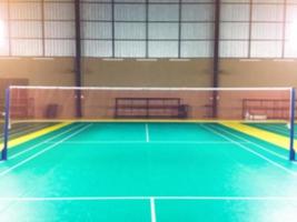 Blurred image of indoor badminton court in local area for playing badminton afterwork. photo