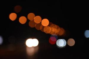 Bokeh street light at night time in urban city of thailand. photo