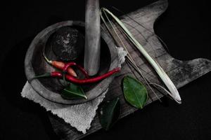 wooden mortar and pestle with herbs. suitable for traditional food campaign photo