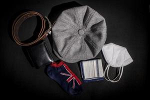 set of dad stuff, newsboy cap, shocks, leather belt, face mask, sniffer on black background. photo