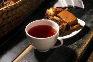 sweet cake and tea on wooden table photo