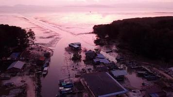 Orbit shot traditional fishing village during sunset hour. video