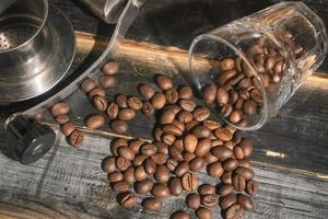 Coffee beans spill from the glass photo