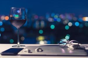 A glass of red wine put on table photo