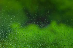 Blurred and focus of rain drop on glass window. photo