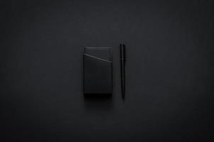 Name card box and pen in modern lifestyle on dark background for minimalist flat lay black concept. photo