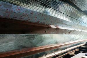 Insulation of the roof of the house on the inside with the use of a wrapper film and fixing boards photo