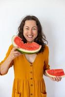 Smiling girl eating watermelon photo