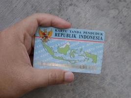 Sidoarjo, Jawa timur, Indonesia, 2022 -  a man holding an Indonesian Identity Card KTP photo