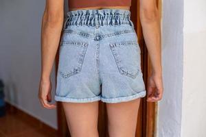 Slim girl in denim shorts photo