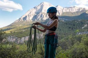 A rock climber prepares equipment for climbing photo