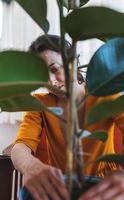 A woman is replanting a home plant photo