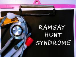 Health and medicine concept for Ramsay Hunt Syndrome medical term on black background with medical equipment's. photo