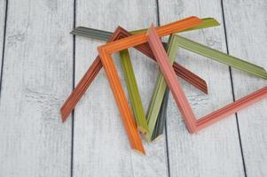 Baguette frames for paintings and images. Frame corners, samples of colored baguettes on a wooden gray background photo