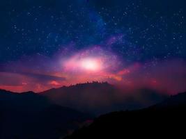 Milky Way and pink light at mountains. Night colorful landscape. Starry sky with hills. Beautiful Universe. Space background with galaxy. Travel background photo