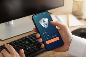 Cybersecurity internet and networking concept. hand holding smartphone information security and encryption, secure access to user's personal information, secure Internet access. photo