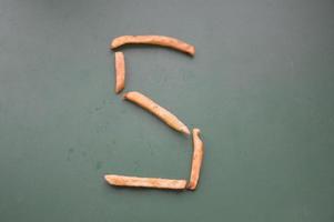 Letters of the english alphabet laid out from french fries photo