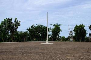 Flagpole in the middle of the field photo