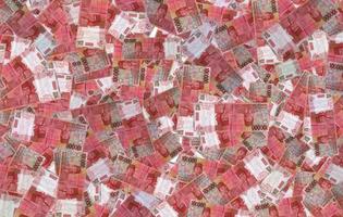 rain of money prizes on the background of 100000 rupiah in Indonesian currency photo