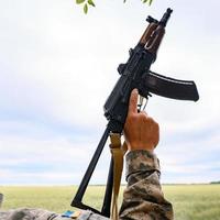 The Ukrainian military holds a submachine gun. photo