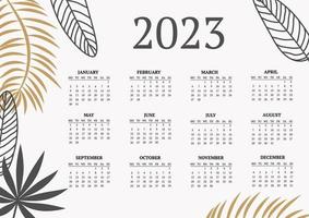 classic monthly calendar for 2023. Calendar with palm and monstera leaves, white and gold color