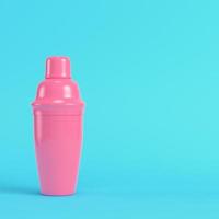 Pink cocktail shaker on bright blue background in pastel colors photo