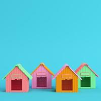 Four colorful doghouses on bright blue background in pastel colors photo