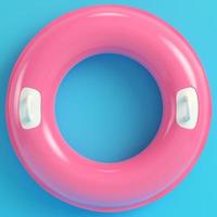 Pink inflatable ring on bright blue background in pastel colors photo