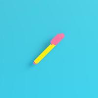 Yellow marker pen on bright blue background in pastel colors. Minimalism concept photo