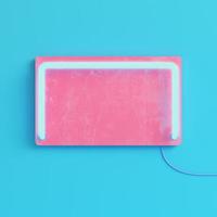 Pink plate with neon light on bright blue background in pastel colors photo