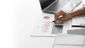 Business people discussing the charts and graphs showing the results of their successful teamwork, Financial inspector calculating a numbers in office room. photo