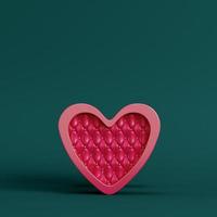 Red abstract heart shape on pedestal with circle frame on dark green background. Minimalism concept photo