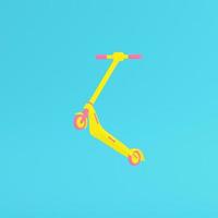 Yellow kick scooter on bright blue background in pastel colors. Minimalism concept photo