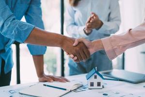 A group of architects are designing a house model, engineers and architects working together to plan a house building project. photo