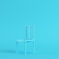 Chair on bright blue background in pastel colors. Minimalism concept photo