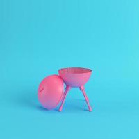 Charcoal kettle barbecue grill on bright blue background in pastel colors photo