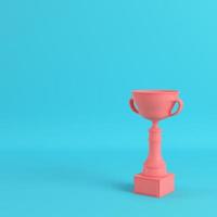 Trophy cup on bright blue background in pastel colors photo