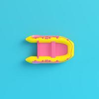 Yellow Inflatable boat on bright blue background in pastel colors photo