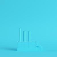 Factory on bright blue background in pastel colors photo