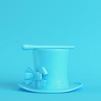 Top hat and magic wand on bright blue background in pastel colors photo