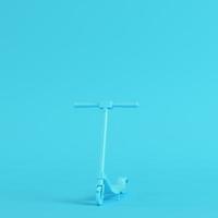 Kick scooter on bright blue background in pastel colors. Minimalism concept photo